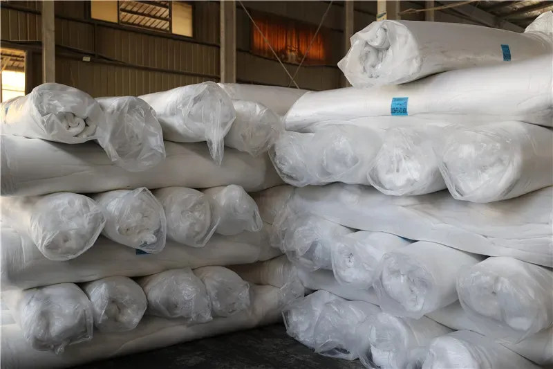 Bagged and rolled premium polyester fiberfill stored in a warehouse for plush toy production