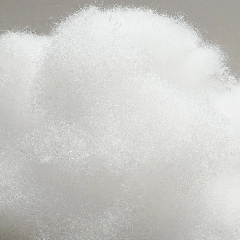 Close-up of clean white polyester fiberfill with a uniform fluffy texture for premium plush toy filling